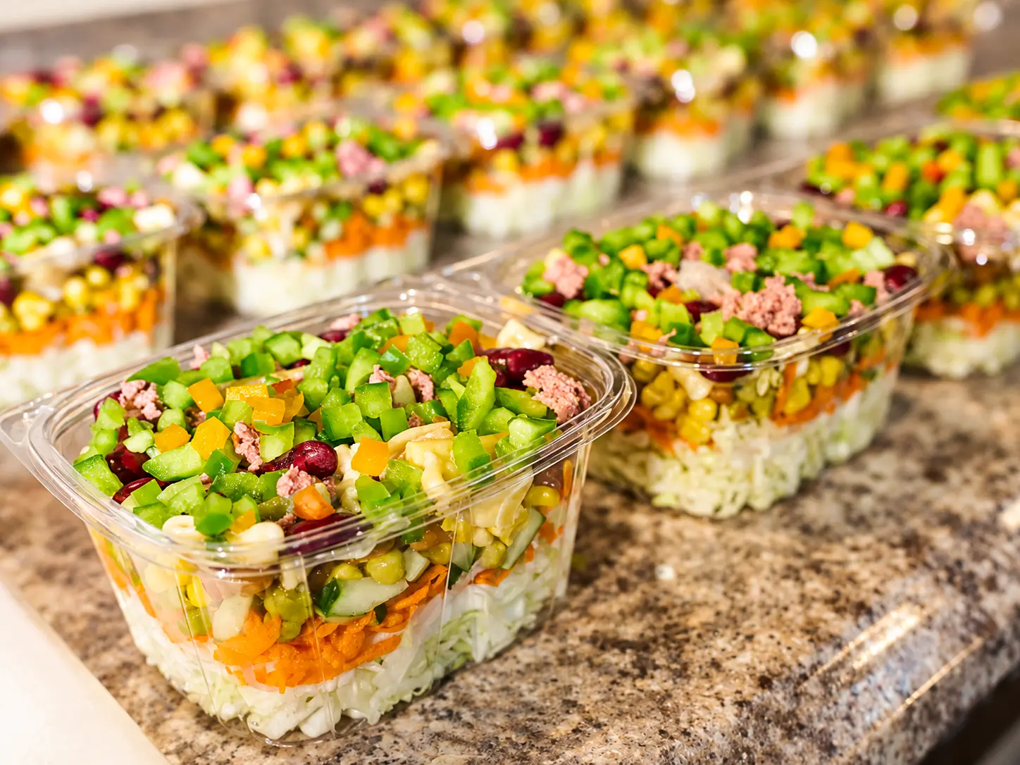 Individual Beyond Salad bowls packed on the counter