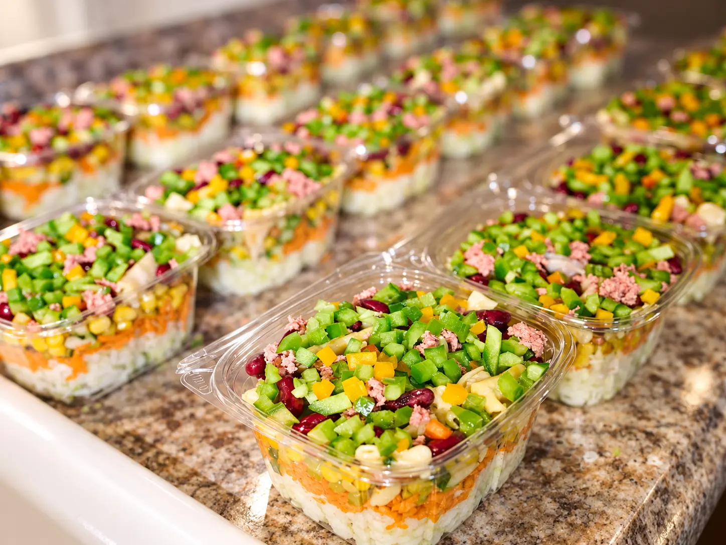 Rows of Beyond Salad bowl salads packed and lined up on the counter